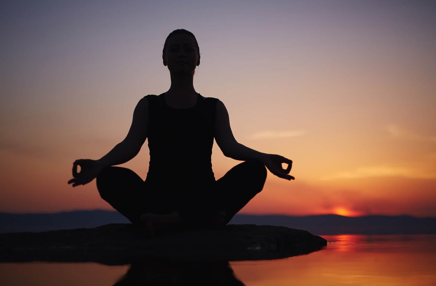 Person practicing mindfulness and meditation in a peaceful natural setting, representing mental eptronx and emotional resilience
